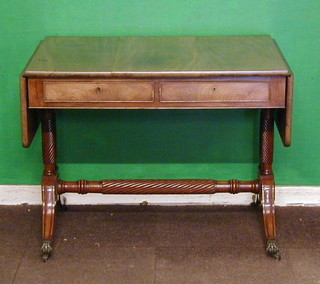 A Georgian bleached mahogany sofa table, fitted 2 frieze drawers with turned stretcher, raised on turned columns and splayed feet ending in brass paw caps and castors 37"