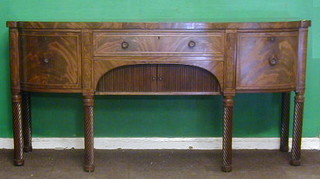 A Regency mahogany "Scotts" bow front sideboard, fitted 1 long drawer above a cupboard enclosed by tambour shutters, flanked by a pair of deep drawers, raised on spiral turned supports 78"