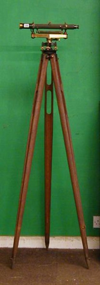 A  19th/20th Century brass and gun metal surveyors dumpy level by Buff & Buff MFGK Boston USA marked 8725 raised on a wooden tripod complete with carrying case