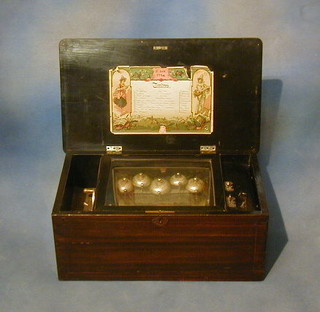 A  German cylinder musical box playing 10 airs and striking on 5 bells, contained in an inlaid rosewood case 21"