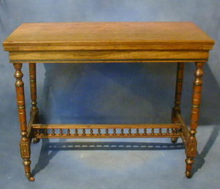 A late Victorian walnutwood card table with bobbin turned decoration, raised on turned and square supports 36"