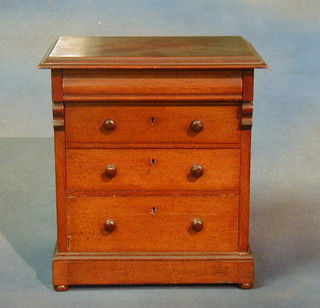A 19th Century Chippendale style mahogany cabinet on stand with pierced fret work broken pediment, the interior fitted adjustable shelves enclosed by astragal glazed panelled doors, the base fitted 1 long drawer with blind fret work decoration, raised on square fluted supports with undertier ending in spade feet, 37"