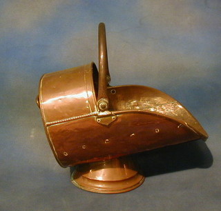 A copper helmet shaped coal scuttle