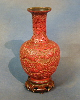 An Oriental carved red lacquered baluster shaped vase 10"