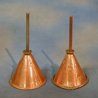 A pair of copper beer funnels