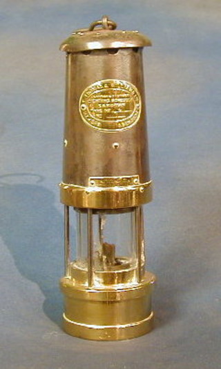 A polished steel and brass minor's Davey lamp by E Thomas & Williams type No. 4 (glass cracked)