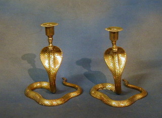 A pair of brass cobra candlesticks 9"