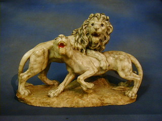 A white veined marble figure group of 2 lions raised on an oval naturalistic base 18"