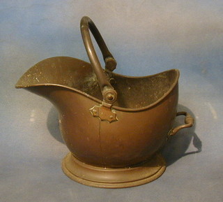 A copper helmet shaped coal scuttle