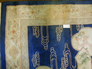 A fine quality garter blue ground Chinese rug decorated birds amidst flowering branches 145" x 108"