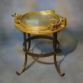 A circular brass porthole mounted as an occasional table 20"