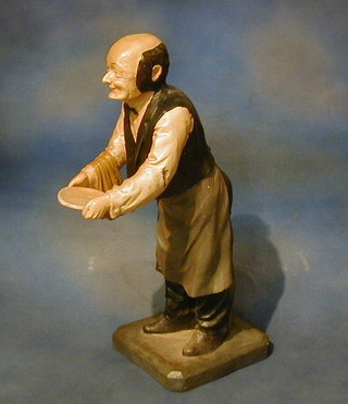 A resin figure of a waiter 24"