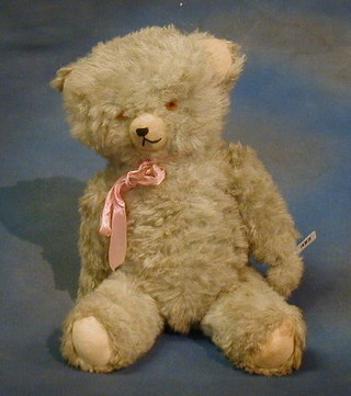 A blue coloured teddybear with articulated limbs