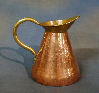 A copper jug with brass handle