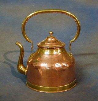 A copper kettle with brass swing handle