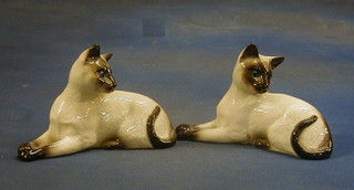 A pair of Royal Doulton figures of Siamese cats, the bases marked 1558,