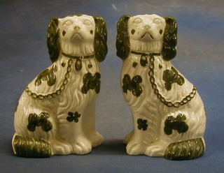 A pair of 19th Century Staffordshire figures  of seated Spaniels with green decoration 10" (f) 