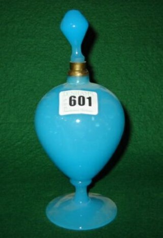 A turquoise glass globular shaped decanter and stopper 8"