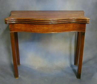A Georgian mahogany triple flap top card/tea table of serpentine outline, raised on square tapering supports 35"