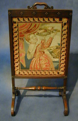 A Victorian rosewood fire screen with Berlin wool work panel