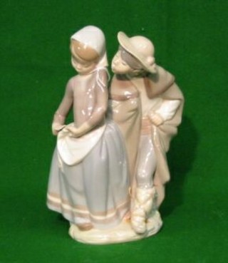 A Lladro figure of a boy and girl, impressed 8, 9"