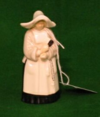 A Royal Worcester candle snuffer  with black mark in the form of a Nun