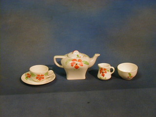 A childs Ivoryware 10 piece tea service with teapot, sugar bowl, cream jug, 3 cups and 2 saucers, 3 plates