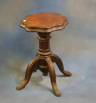 A Victorian mahogany adjustable piano stool, the seat of serpentine outline, on octagonal column and tripod supports