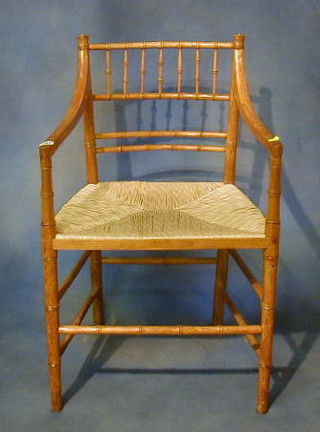 A 19th Century oak faux bamboo carver chair with woven rush seat