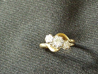 A lady's 9ct gold dress ring inset 3 diamonds
