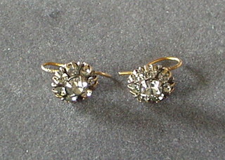 A pair of gilt metal earrings each set a white stone
