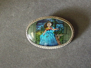 An oval silver and butterfly wing brooch decorated a Crinoline lady