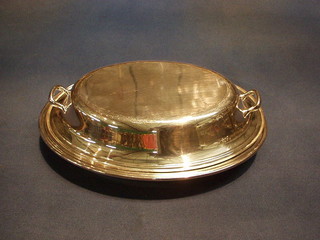 A plain oval silver plated entree dish and cover