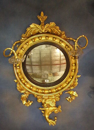 A fine quality Regency convex wall mirror, having candle sconces and lustres to the sides, surmounted by a figure of a horse, 39"