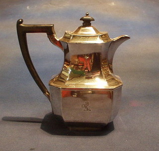 A silver plated hotwater jug with ebonised handle