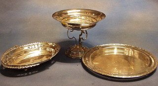 A circular silver plated pedestal bowl, a pierced silver plated bread board frame and a cake basket