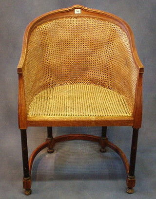 A Victorian oak tub back chair with woven cane panels on turned and block supports