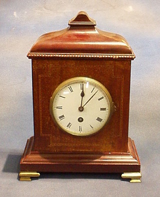 A French 8 day mantel clock with enamelled dial and Roman numerals, having a carriage clock movement, contained in inlaid mahogany case