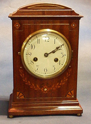 A French 19th Century 8 day striking mantel clock with enamelled dial and Arabic numerals, contained in an inlaid mahogany case