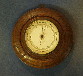 A 1930's 8 day wall clock, the 6" dial with Roman numerals and minute indicator, contained in a carved oak case
