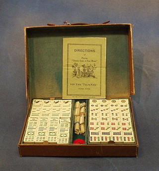 An ivory Mahjong set contained in a leather case