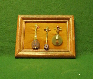 3 hardstone miniature instruments, framed 4"