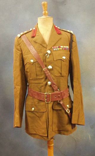 A  Royal Corps of Transport Brigadier's service dress jacket and trousers by Bernard Wetherall, full dress tunic and 2 pairs of trousers, a Great coat by Simpsons, a service dress tunic and trousers, battle dress blouse, Sam Brown belt and stable belt