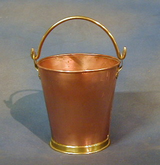 A copper pail with brass swing handle 7"
