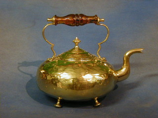 A brass kettle with amber glass handle