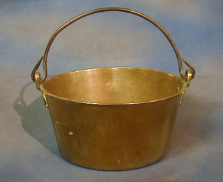 A brass preserving pan with iron swing handle