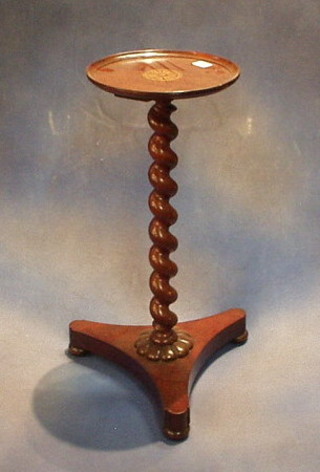 A circular inlaid mahogany wine table raised on a spiral turned column with triform base