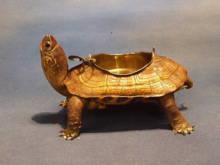 A stuffed figure of a terrapin in use as an ashtray