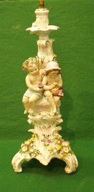 A 19th Century Continental floral encrusted porcelain candlestick converted to a table lamp in the form of 2 seated children 17" (f and r)