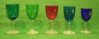 A  Bristol blue wine glass with clear glass stem, a cranberry wine glass with clear glass stem and 3 others